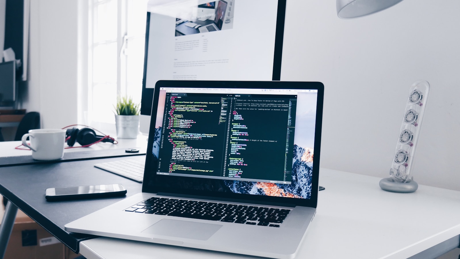 Modern designer workstation with laptop code editor and enterprise SaaS settings hierarchy documentation