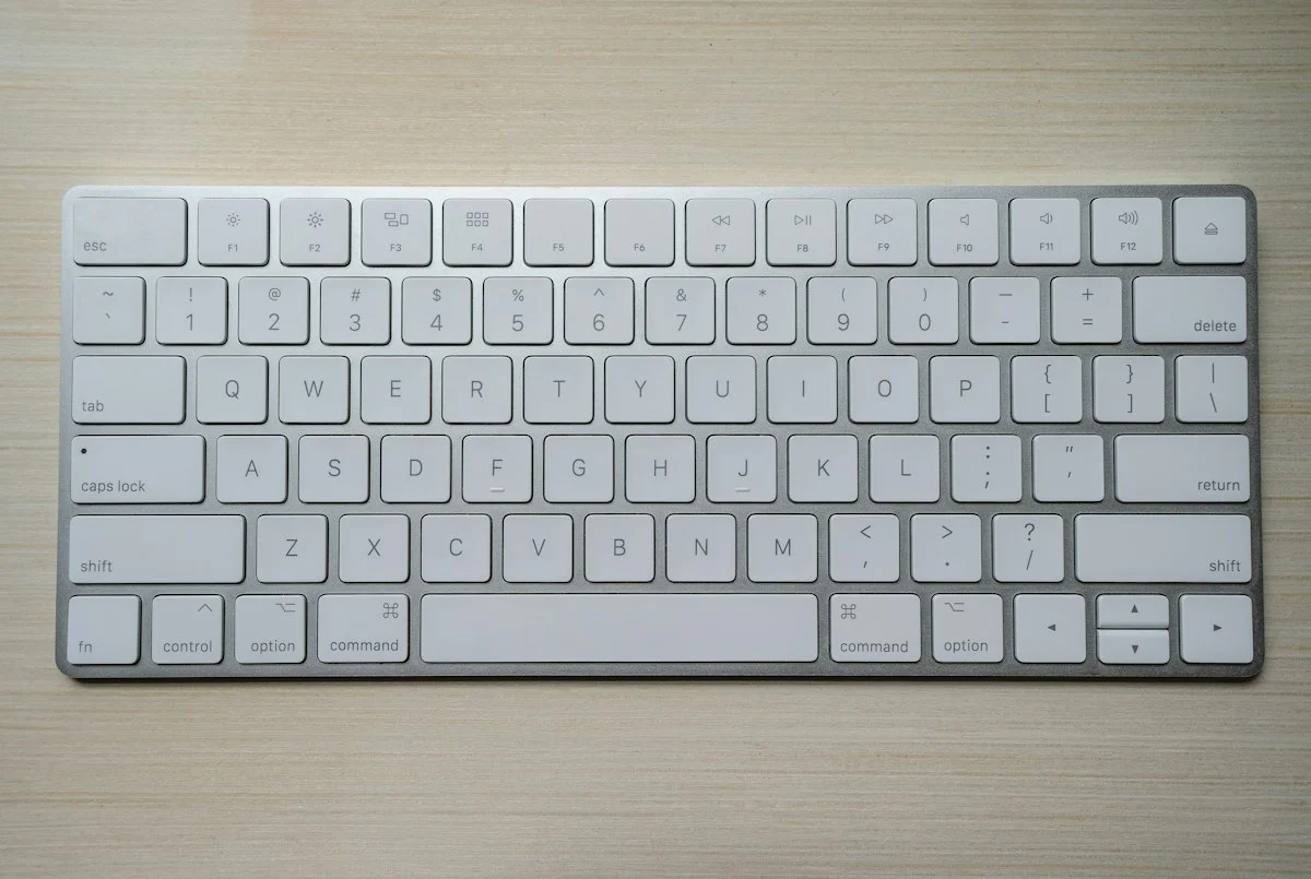 Minimalist mechanical keyboard with custom keycaps on a modern executive workstation